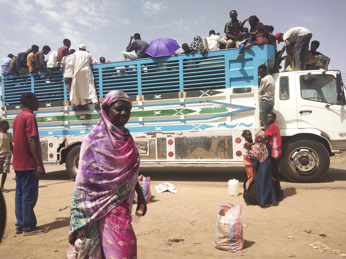 People board a truck as they leave Khartoum, Sudan, Monday, June 19, 2023. Sudan's warring parties have begun another attempt at a cease-fire after more than two months of brutal fighting ? and a ...