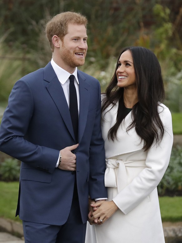 Britain's Prince Harry and his fiancee Meghan Markle pose for photographers during a photocall in the grounds of Kensington Palace in London, Monday Nov. 27, 2017. Britain's royal palace say ...