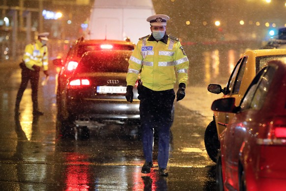 Traffic policemen check the documents of drivers in Bucharest, Romania, Monday, March 23, 2020. Romanian police started enforcing a partial lockdown, meant to limit the spread of the new coronavirus,  ...