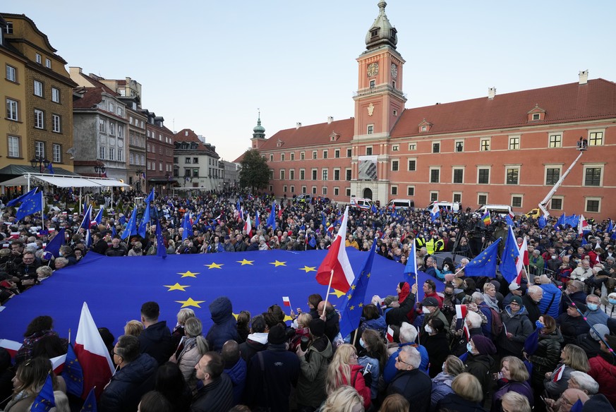 People wave EU and Polish flags in support of Poland&#039;s EU membership during a demonstration, in Warsaw, Poland, Sunday, October 10, 2021. Poland&#039;s constitutional court ruled Thursday that Po ...