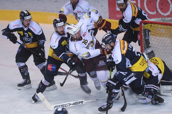 From left, Ambri&#039;s player Marco Mueller, Ambri&#039;s player Tommaso Goi, Geneva&#039;s player Eric Fehr and Ambri&#039;s player Zaccheo Dotti, during the preliminary round game of National Leagu ...