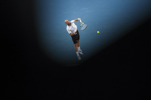 epa09699673 Adrian Mannarino of France serves during his third round match against Aslan Karatsev of Russia at the Australian Open Grand Slam tennis tournament in Melbourne, Australia, 21 January 2022 ...
