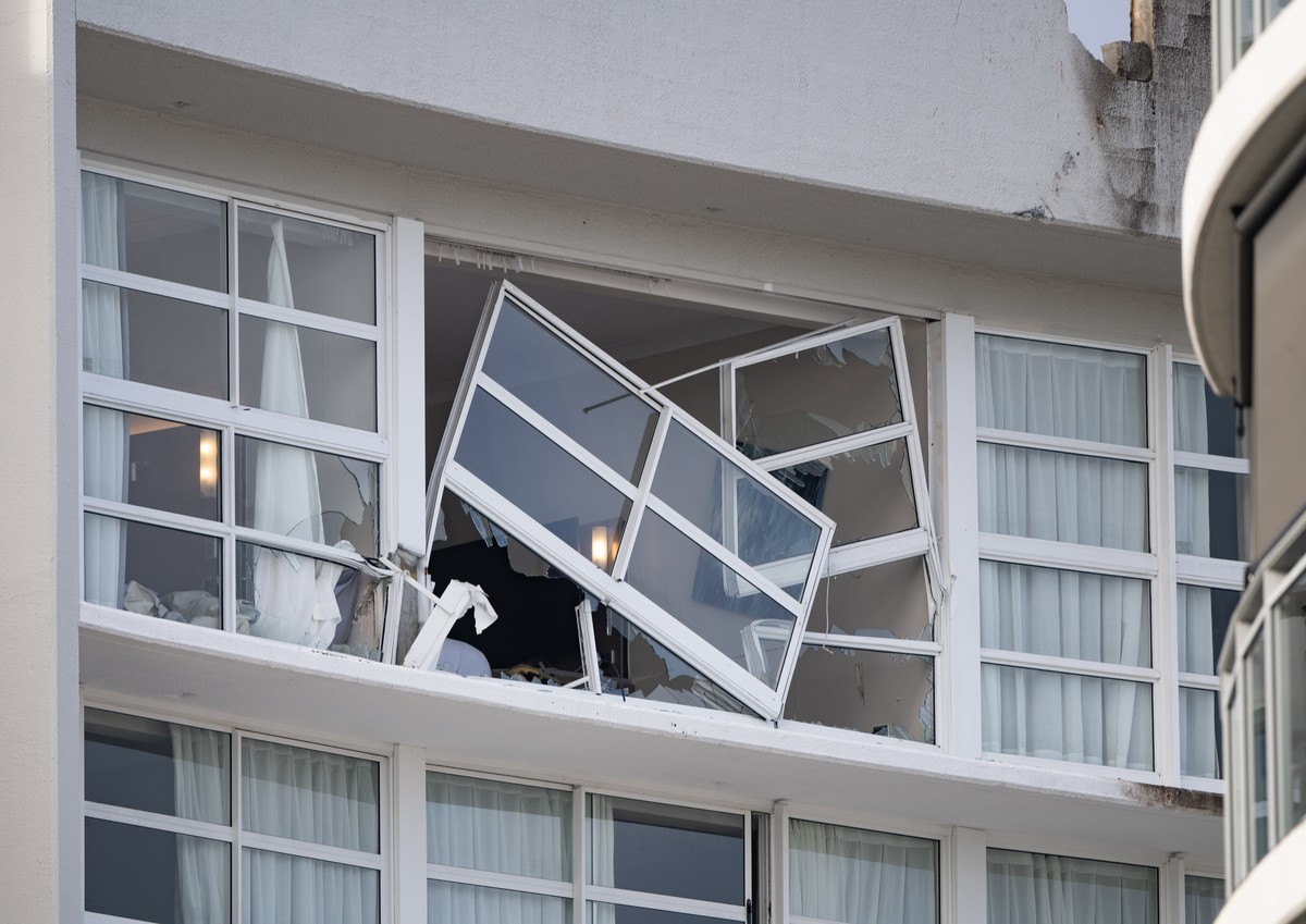 epa11546233 A broken window and damaged rooftop is seen at the Double Tree by Hilton Hotel after a helicopter crashed into its roof, in Cairns, Australia 12 August 2024. Police have declared a Public  ...