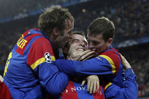 Basel's Alex Frei, center, celebrates after scoring the 2-0 with teammates Marco Streller, left, and Fabian Frei, right, during the UEFA Champions League Group C soccer match between Switzerland& ...