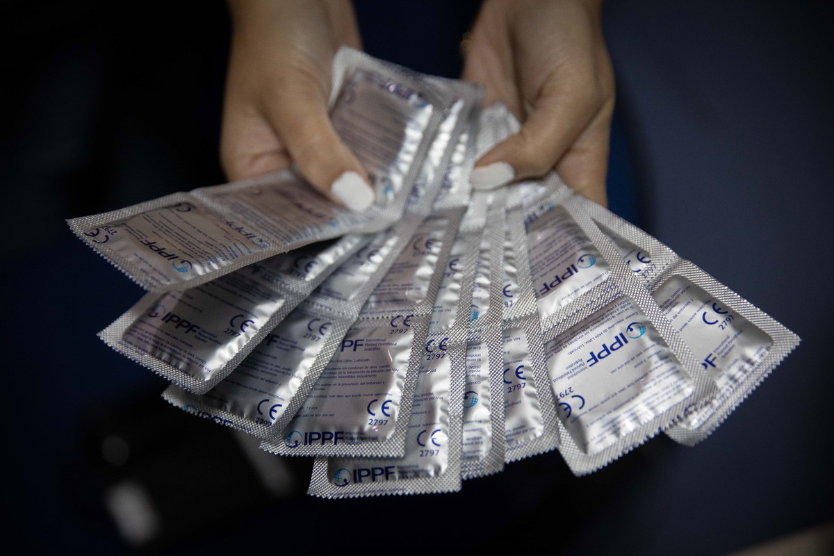 epa09467939 A social worker shows condoms before a donation at the Plafam Clinic in Caracas, Venezuela, 13 September 2021 (issued 14 September 2021). The shortage of contraceptive methods in Venezuela ...