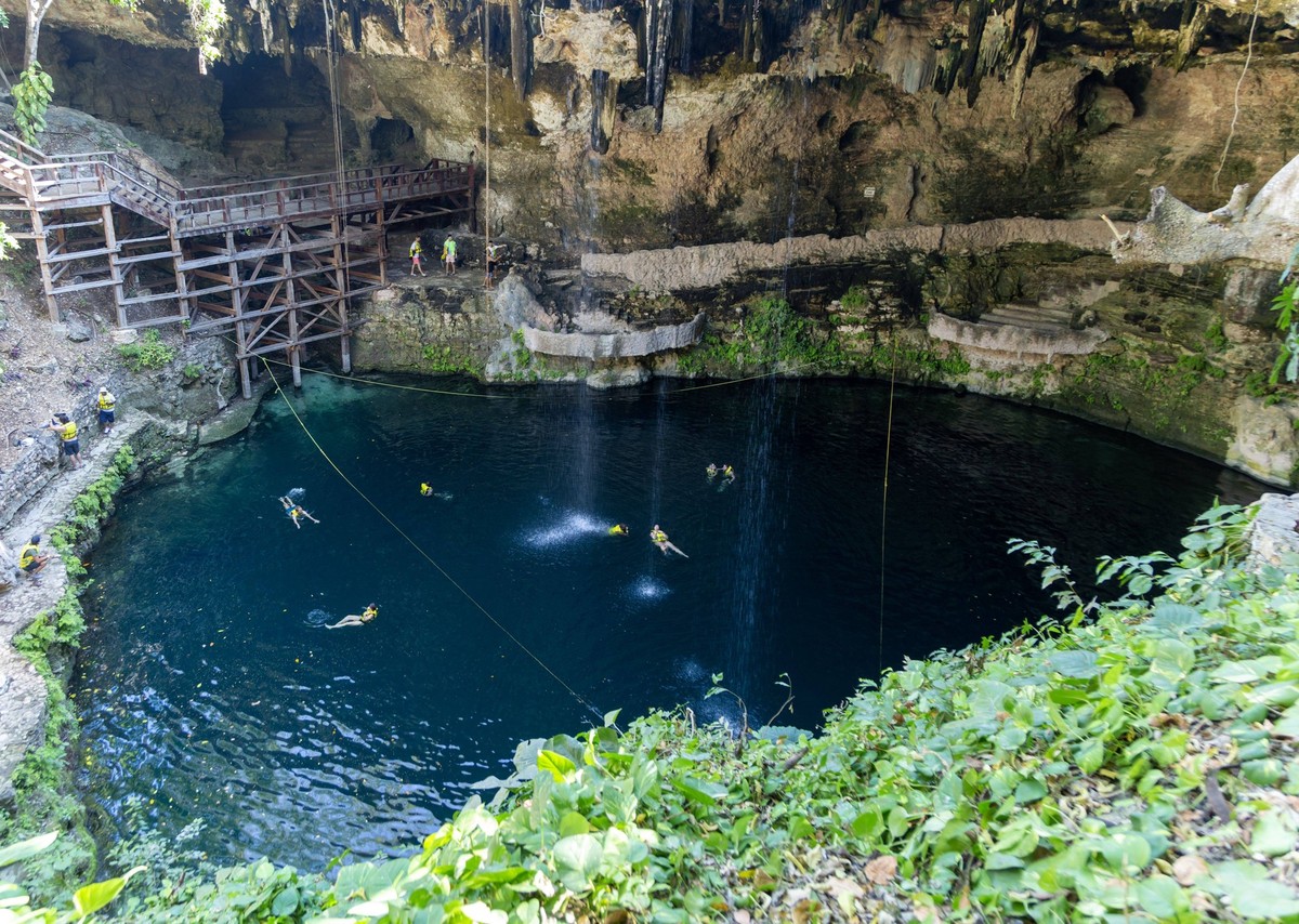 People swimming in Cenote Zaci carboniferous limestone swallow hole pool, Vallodolid, Yucatan, Mexico People swimming in Cenote Zaci carboniferous limestone swallow hole pool, Vallodolid, Yucatan, Mex ...