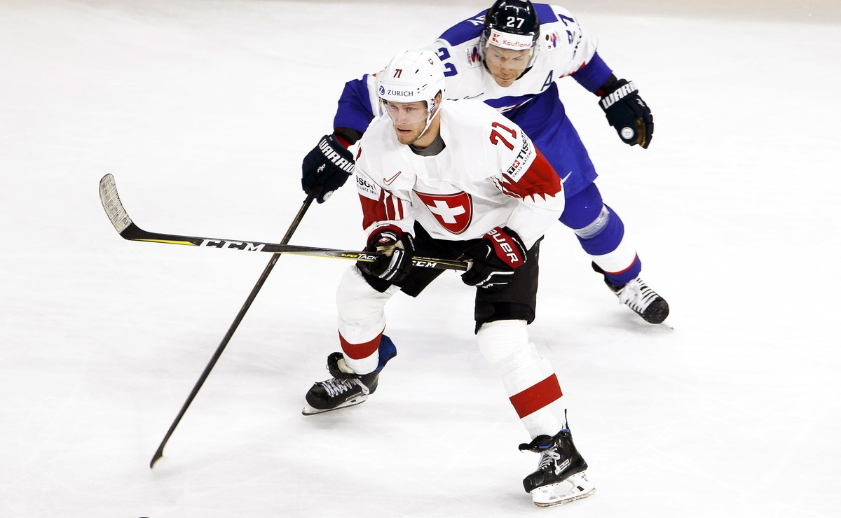 epa06715813 Switzerland's forward Enzo Corvi (front) in action against Slovakia's forward Ladislav Nagy (back) during the IIHF World Championship Group A ice hockey match between Slovakia an ...