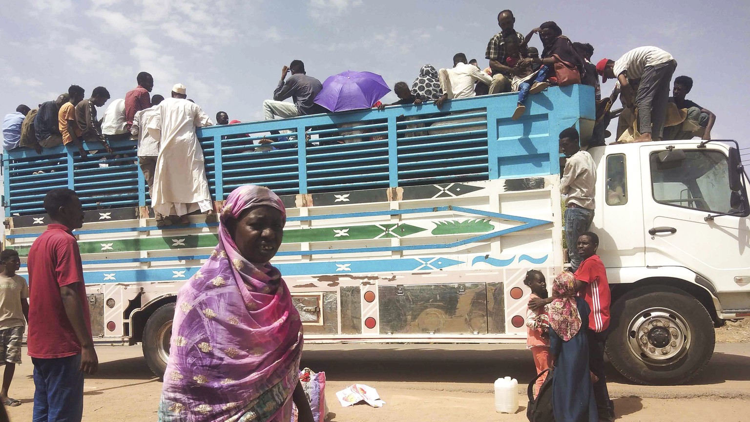 FILE - People board a truck as they leave Khartoum, Sudan, on June 19, 2023. Sudan has been torn by war for a year now, torn by fighting between the military and the notorious paramilitary Rapid Suppo ...
