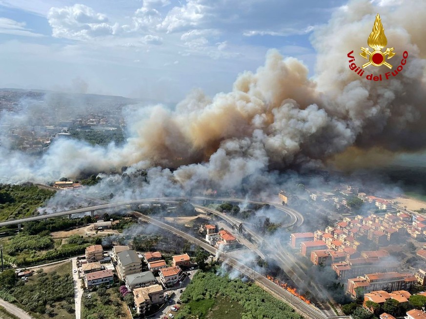 epa09387602 A handout photo made available by Vigili del Fuoco (VVF), the Italian National Fire Brigade, shows an aerial view of a fire in the Pineta Dannunziana reserve in Pescara, Abruzzo region, ce ...