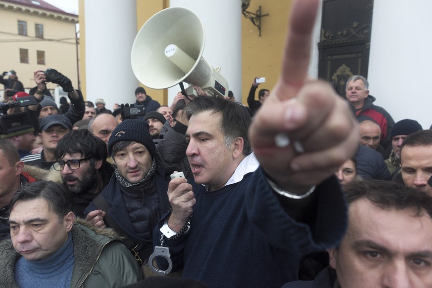 Former Georgian president Mikheil Saakashvili, center, addresses protesters after he escaped with help from supporters and led them on a march toward parliament, where they planned to call for Preside ...