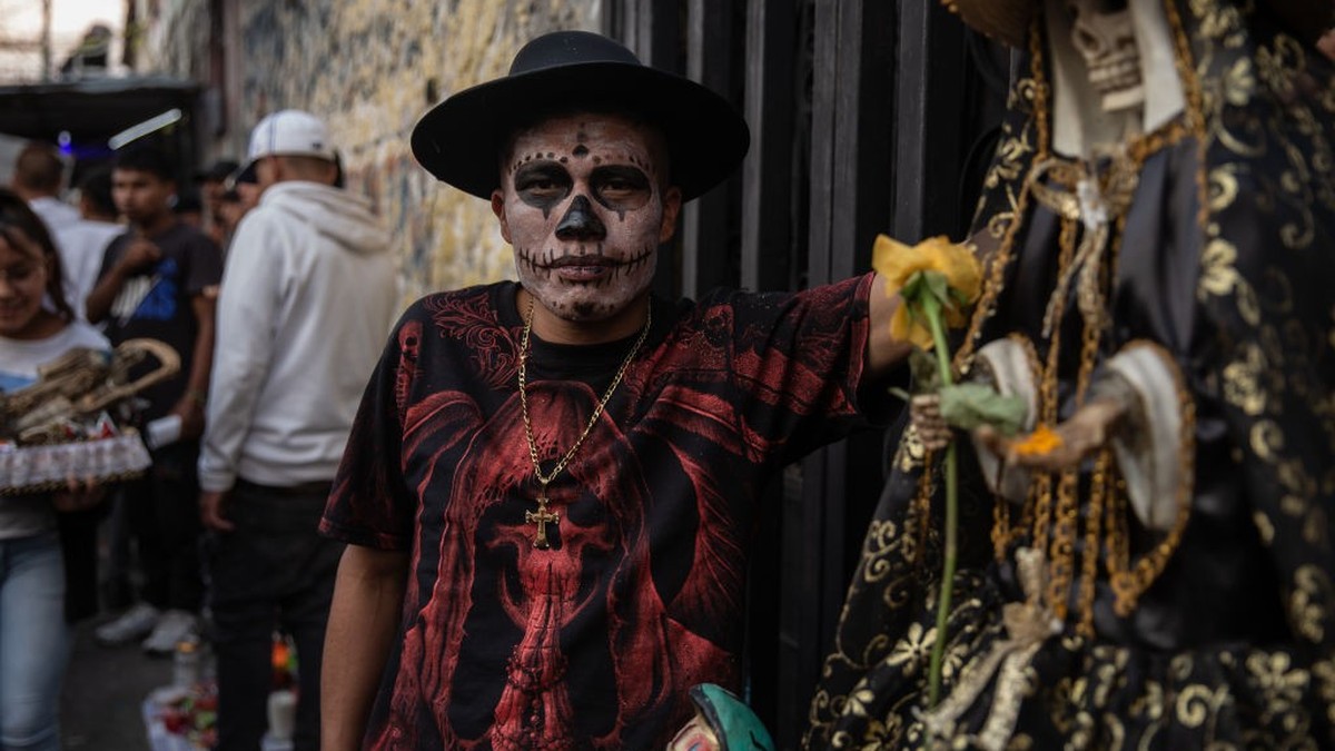 TEPITO, MEXICO - NOVEMBER 01: A man with a his face painted as a skelton poses on November 01, 2022 in Tepito, Mexico. People from across the city go to Tepito, the most notorious neighbourhood run by ...