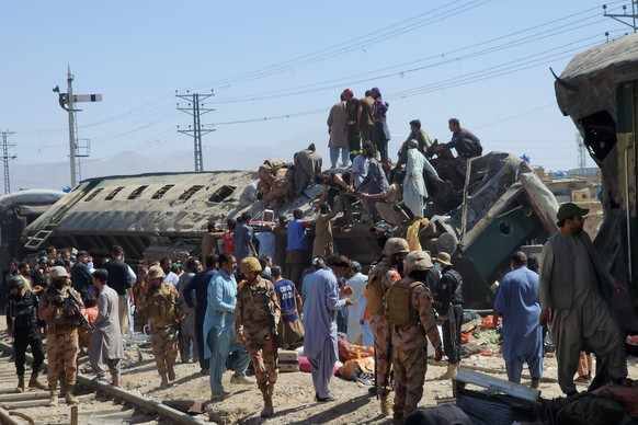 epa12989501 Security officials and rescuers gather near wrecked train carriages at the scene of a deadly blast in Quetta, Pakistan, 24 May 2026. Several people were killed, dozens more injured, and mu ...