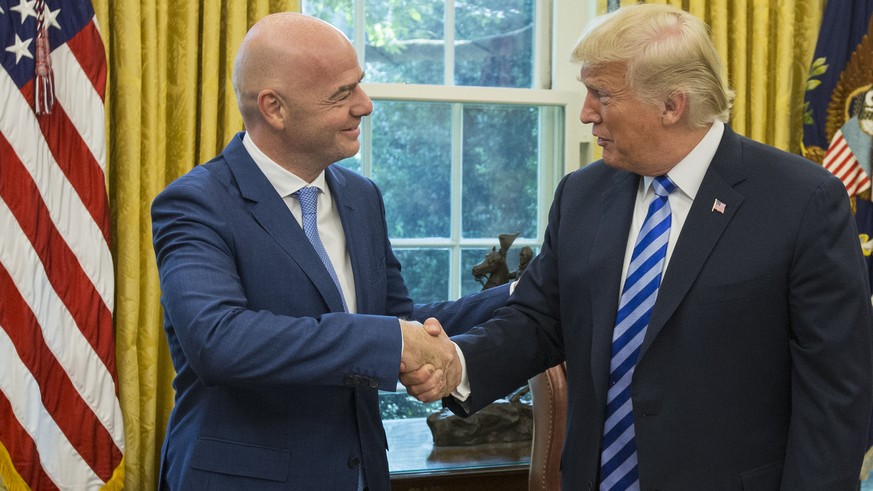 epa06979413 US President Donald J. Trump (R) shakes hands with President of FIFA Gianni Infantino (L) during their meeting in the Oval Office of the White House in Washington, DC, USA, 28 August 2018. ...