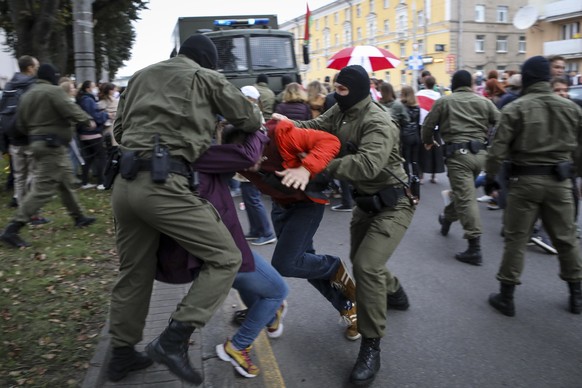 FILE - Police officers detain protesters during a rally in support of opposition figure Maria Kolesnikova in the capital of Minsk, Belarus, on Tuesday, September 8, 2020. It has been a year since Koles...