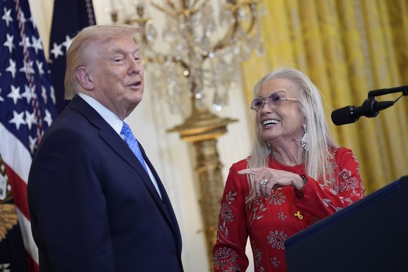 epa12597489 US President Donald Trump (L) talks with Miriam Adelson (R) during a Hanukkah reception in the East Room at the White House in Washington, DC, USA, 16 December 2025. EPA/YURI GRIPAS / POOL