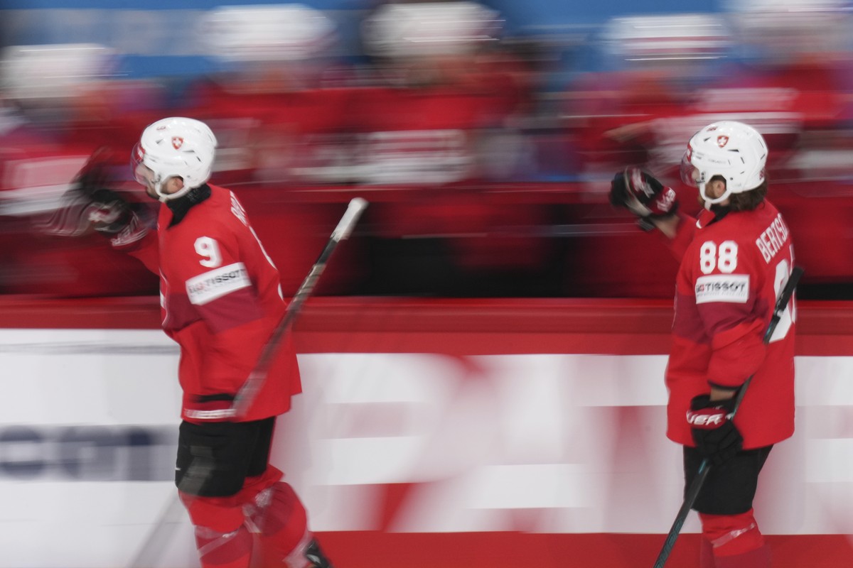 Switzerland's Damien Riat, left, and Christoph Bertschy celebrate after a goal during the semifinal match between Denmark and Switzerland at the ice hockey world championships in Stockholm,Sweden ...