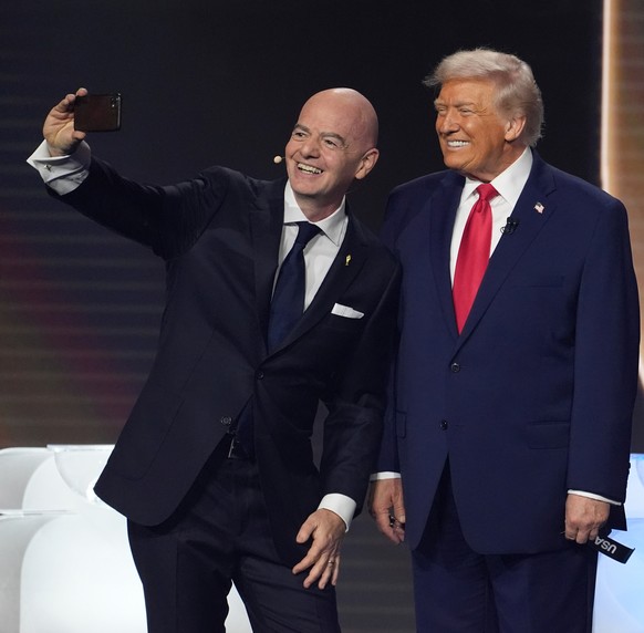 From l-r., FIFA President Gianni Infantino takes a selfie with President Donald Trump, Mexican President Claudia Sheinbaum, and Canadian Prime Minister Mark Carney during the draw for the 2026 soccer  ...