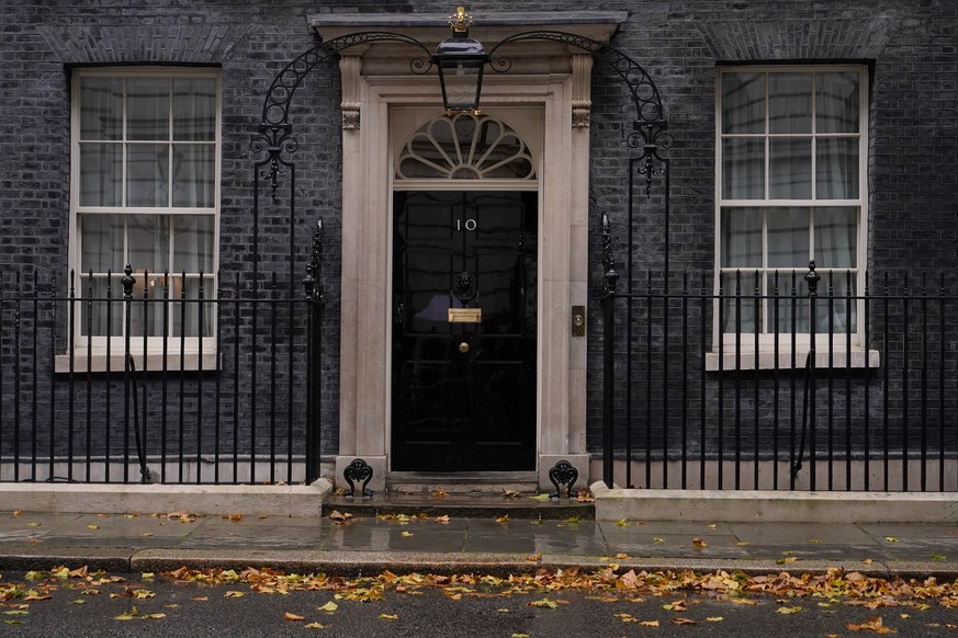 Rain and fallen leaves create an autumn atmosphere at 10 Downing Street in London, Thursday, Oct. 20, 2022. U.K. Prime Minister Liz Truss is hanging on to power by a thread after a senior minister qui ...