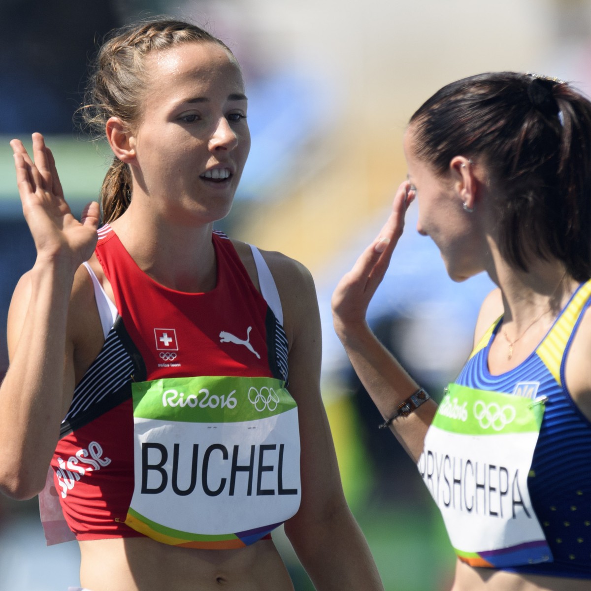 Selina Buechel, left, of Switzerland reacts after winning the women's 800m Round 1 heat in the Olympic Stadium at the Rio 2016 Olympic Summer Games in Rio de Janeiro, Brazil, on Monday, August 17 ...