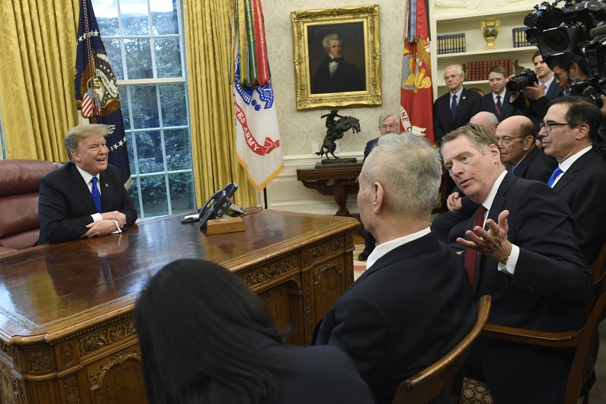 President Donald Trump, left, talks at the same time that U.S. Trade Representative Robert Lighthizer, second from right, talks with Chinese Vice Premier Liu He, second from left, during their meeting ...