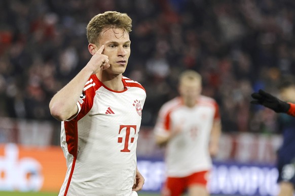 epa11285373 Munich's Joshua Kimmich celebrates after scoring 1-0 during the first leg of the UEFA Champions League quarter-final between Bayern Munich and Arsenal in Munich, Germany, April 17, 2024.
