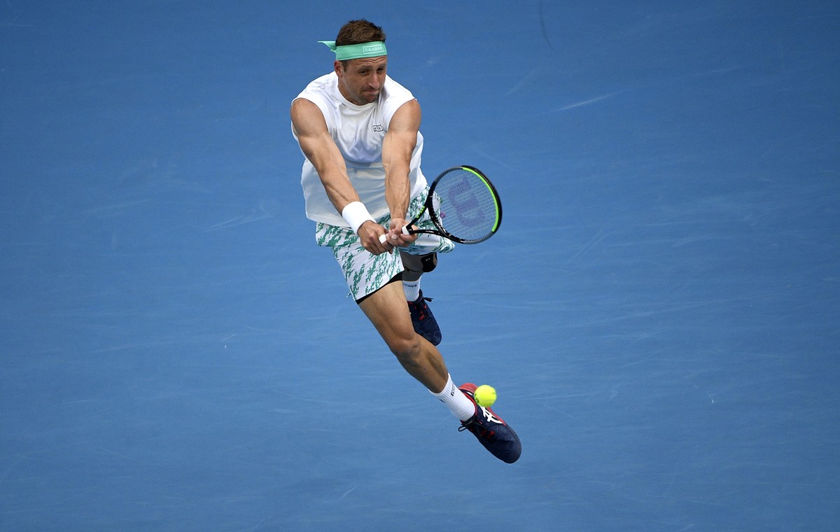 Tennys Sandgren of the U.S. makes a backhand return to Italy's Fabio Fognini during their fourth round singles match at the Australian Open tennis championship in Melbourne, Australia, Sunday, Ja ...