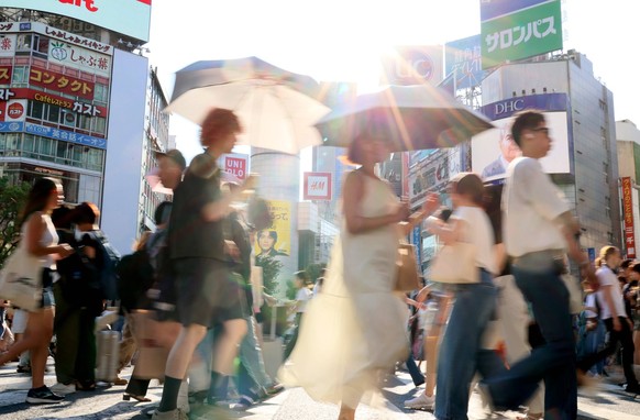 News Bilder des Tages July 17, 2023, Tokyo, Japan - People cross a road in Tokyo s Shibuya fashion district on Monday, July 17, 2023. A heat wave attacked Tokyo metropolitan area and many people suffe ...
