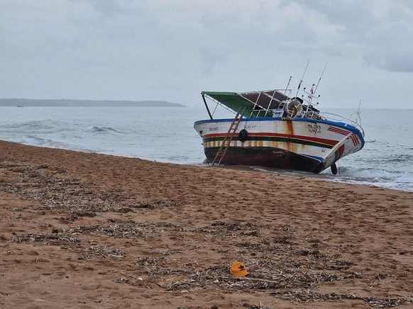 epa10944700 A view of the boat used for the crossing of the Mediterranean Sea by dozens of migrants on the beach of Marinella di Selinunte, Sicily, Italy 28 October 2023. Five bodies were recovered on ...