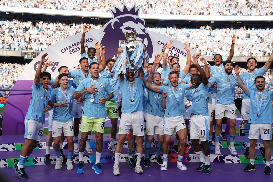 FILE - Manchester City players celebrate with the Premier League trophy after the English Premier League soccer match between Manchester City and West Ham United in Manchester, England, Sunday, May 19 ...