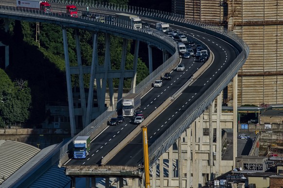 Cars and trucks are left on a section of the collapsed Morandi highway bridge in Genoa, northern Italy, Wednesday, Aug. 15, 2018. A bridge on a main highway linking Italy with France collapsed in the  ...