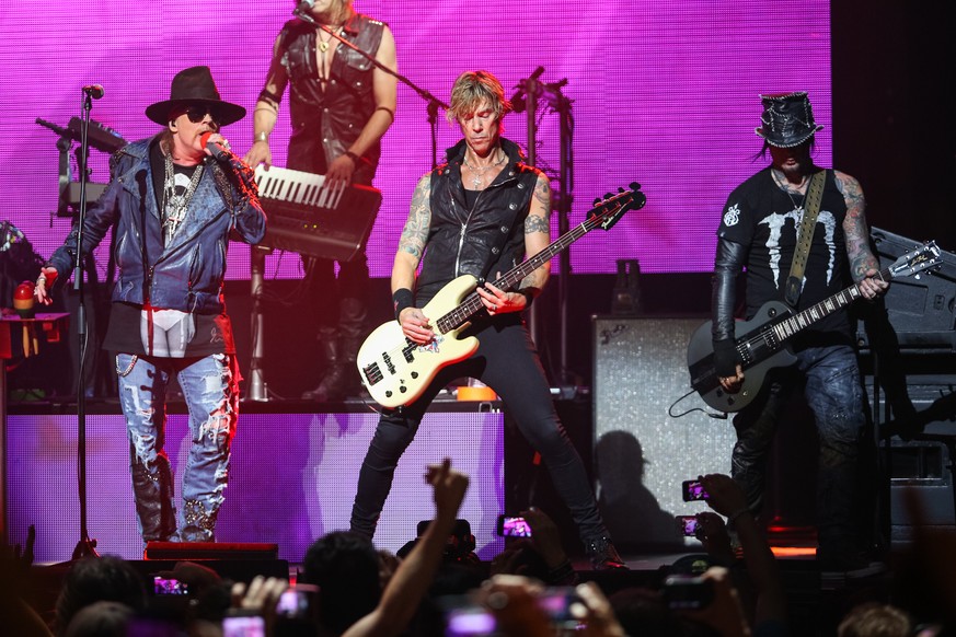 FILE - In this April 23, 2014 file photo, Axl Rose, from left, Duff McKagan and DJ Ashba of Guns N&#039; Roses perform on stage at the 6th Annual Revolver Golden Gods Award Show at Club Nokia in Los A ...