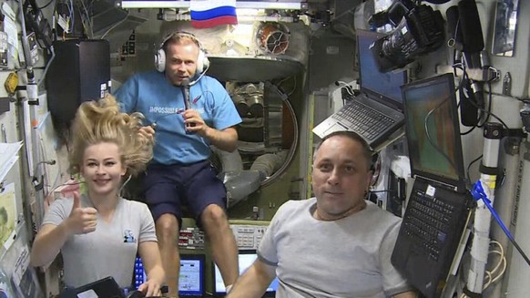 FILE - In this Oct. 7, 2021, file photo taken from video footage released by Roscosmos Space Agency, actress Yulia Peresild, left, film director Klim Shipenko, center, and cosmonaut Anton Shkaplerov s ...