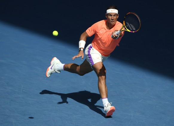 Spain's Rafael Nadal hits a forehand return to Italy's Fabio Fognini during their fourth round match at the Australian Open tennis championship in Melbourne, Australia, Monday, Feb. 15, 2021.(AP Photo ...