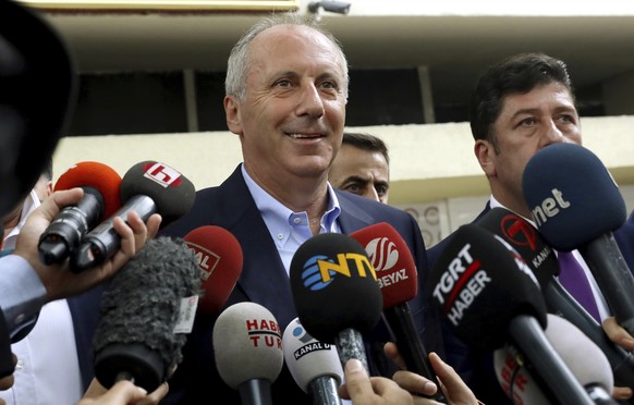 Muharrem Ince, the candidate of Turkey's main opposition Republican People's Party, center, speaks to the media outside High Electoral Board in Ankara, Turkey, Sunday, June 24, 2018. The pol ...