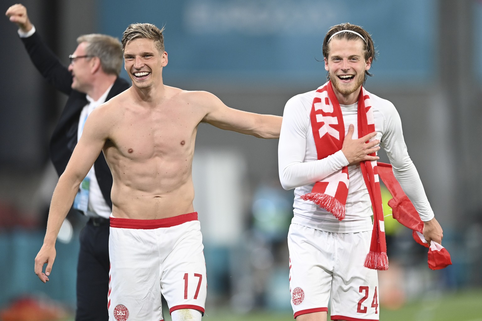 Denmark's Jens Stryger Larsen, left, and Denmark's Mathias Jensen celebrate after the Euro 2020 soccer championship group B match between Russia and Denmark at the Parken stadium in Copenhag ...