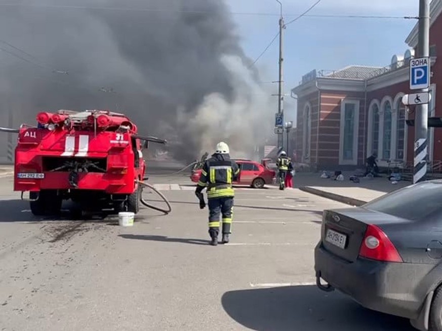 epa09878018 A handout picture made available by the Donetsk Regional State Administration shows emergency services working at the scene after a missile strike hit the railway station in Kramatorsk, Do ...