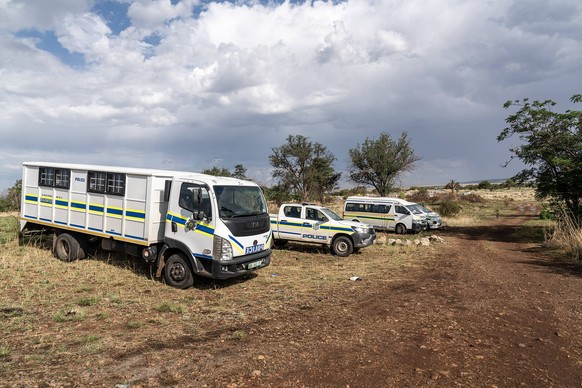 241114 -- JOHANNESBURG, Nov. 14, 2024 -- Police vehicles are seen near the entrance of a mine shaft in Stilfontein, North West Province of South Africa, Nov. 13, 2024. TO GO WITH 4,000 illegal miners  ...