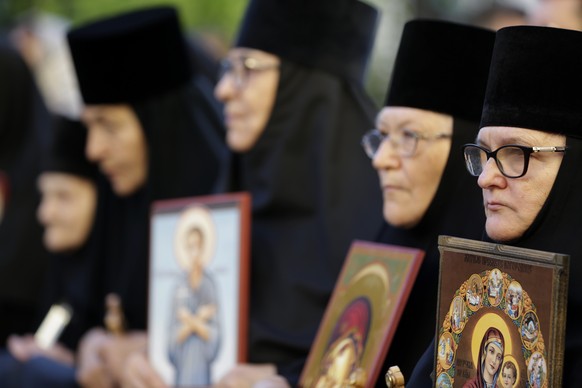 epa10178611 Nun hold icons during a protest against the international LGBTQ event EuroPride in Belgrade, Serbia, 11 September 2022. EuroPride, a pan-European international event dedicated to LGBTQ pri ...