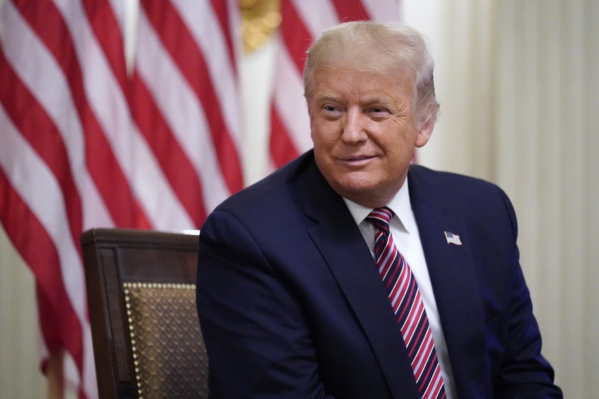 President Donald Trump listens during an event called &quot;Kids First: Getting America&#039;s Children Safely Back to School&quot; in the State Dining room of the White House, Wednesday, Aug. 12, 202 ...