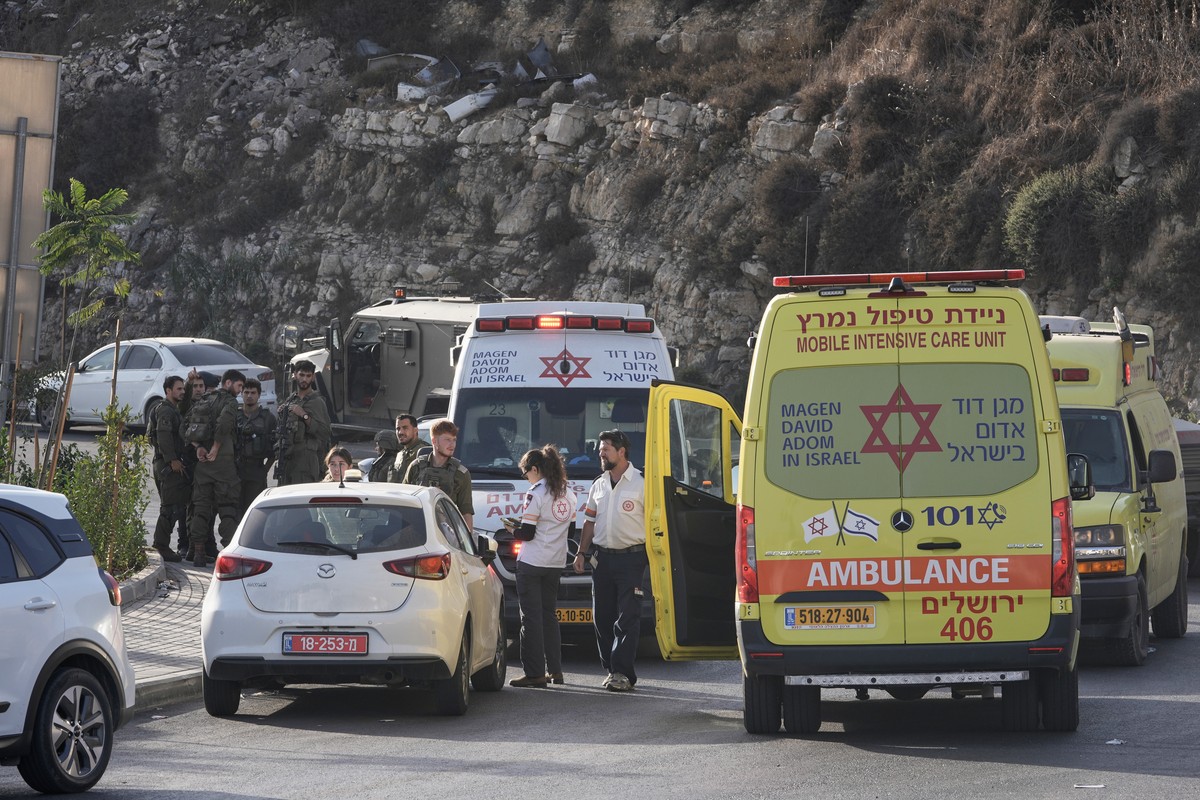 Israeli soldiers and emergency personnel gather near ambulances following a shooting attack near Yehuda Junction, near Hebron, in the occupied West Bank, Friday, Oct. 23, 2026. (AP Photo/Mahmoud Illea ...
