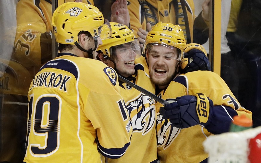 Nashville Predators left wing Kevin Fiala (56), of Switzerland, celebrates with Calle Jarnkrok (19), of Sweden, and Viktor Arvidsson (38), of Sweden, after Fiala scored the winning goal against the Ch ...