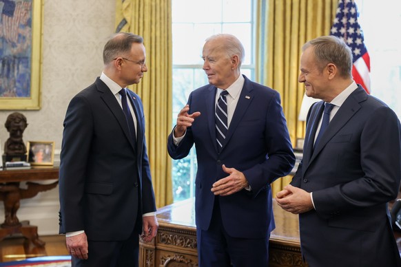 epa11217447 US President Joe Biden (C), Polish President Andrzej Duda (L) and Polish Prime Donald Tusk (R), during their meeting at the White House in Washington, USA, 12 March 2024. Polish President  ...
