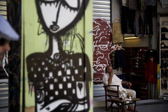 A shop owner sits a a chair as he waits for customers, in Kos, Greece, Monday, July 6, 2015. GreeceÂs Finance Minister Yanis Varoufakis has resigned following SundayÂs referendum in which the majori ...