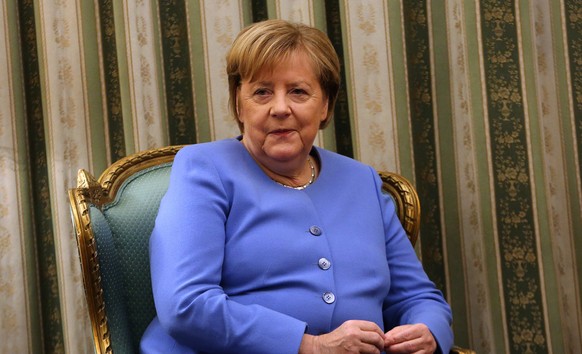 epa09551770 German Chancellor Angela Merkel listens to the Greek President during their meeting at the Presidential Palace, in Athens, Greece, 29 October 2021. Angela Merkel is visiting Greece for the ...