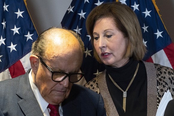 FILE - Former Mayor of New York Rudy Giuliani, left, listens to Sidney Powell, both lawyers for President Donald Trump, during a news conference at the Republican National Committee headquarters, Nov. ...