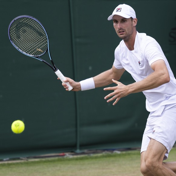 Switzerland&#039;s Alexander Ritschard in action against Duje Ajdukovic of Croatia during the Qualifying competition for the All England Lawn Tennis Championships in Wimbledon, London, Thursday, June  ...