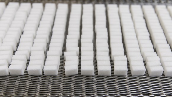 Sugar cubes lie on a conveyor belt, pictured on November 22, 2013, in the sugar factory in Aarberg, canton of Bern, Switzerland. The Zuckerfabriken Aarberg und Frauenfeld (ZAF, sugar factories in Aarb ...