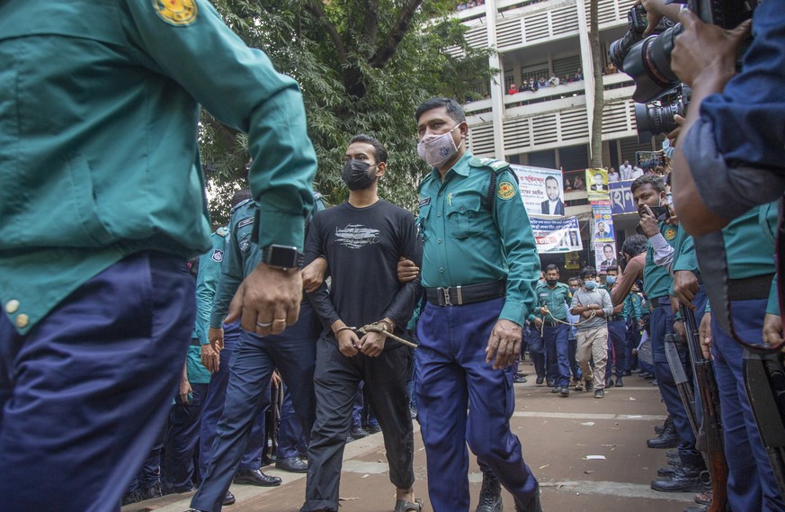 epa09628905 One of the accused of murder is escorted outside the court during the verdict day on the murder of student Abrar Fahad at the Speedy Trial Tribunal-1 in Dhaka court, in Dhaka, Bangladesh,  ...