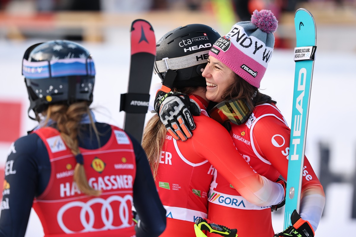 Third placed Switzerland's Wendy Holdener, right, congratulates winner Switzerland's Camille Rast as United States' Mikaela Shiffrin , left, looks on, at the finish line during an alpin ...