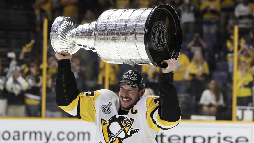 Pittsburgh Penguins&#039; Sidney Crosby (87) celebrates with the Stanley Cup after defeating the Nashville Predators in Game 6 of the NHL hockey Stanley Cup Final, Sunday, June 11, 2017, in Nashville, ...